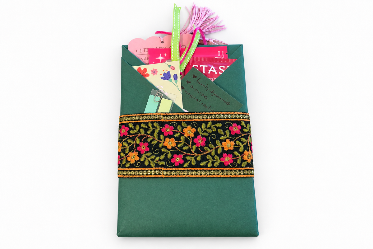 Edited green gift box with black floral ribbon