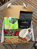 Full holiday journal gift package with a wrapped journal, Crownstreet coffee, and a book-themed mug nestled in a gift box.