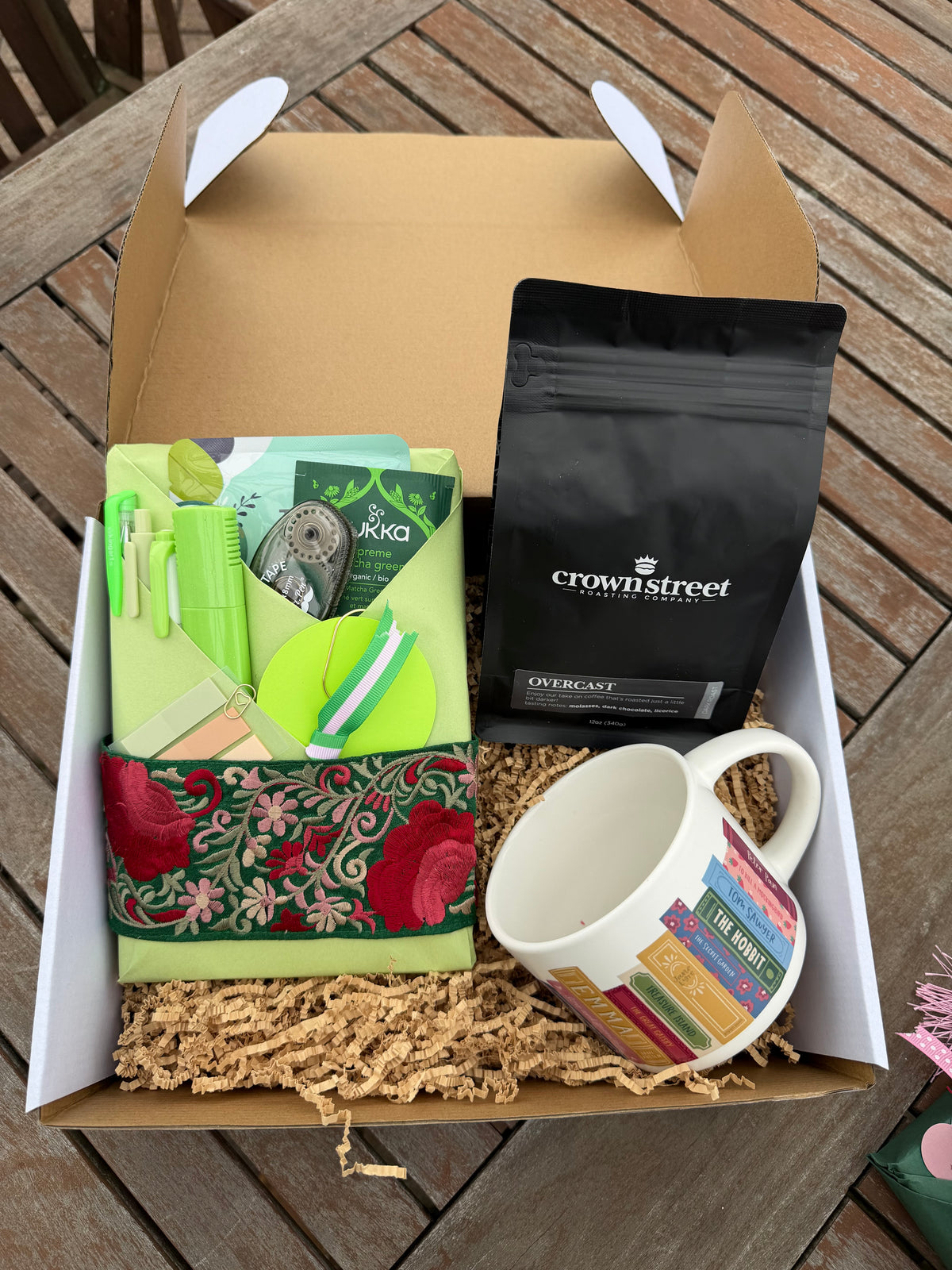 Full holiday journal gift package with a wrapped journal, Crownstreet coffee, and a book-themed mug nestled in a gift box.